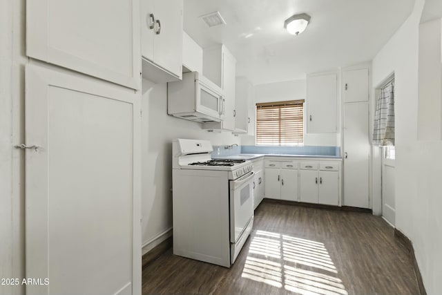 kitchen featuring dark hardwood / wood-style flooring, sink, white cabinets, and white appliances