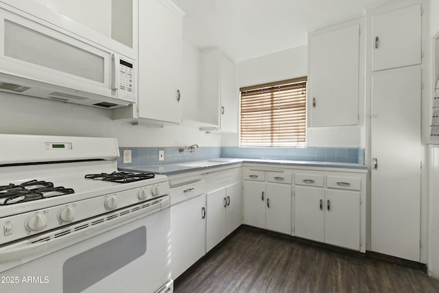 kitchen with sink, white appliances, white cabinets, and dark hardwood / wood-style flooring