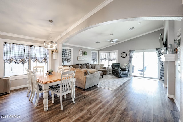 dining room with ceiling fan with notable chandelier, ornamental molding, lofted ceiling, and hardwood / wood-style floors