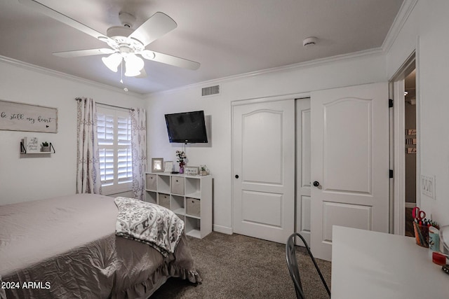 carpeted bedroom with crown molding, ceiling fan, and a closet