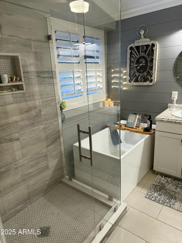 bathroom featuring tile patterned floors, vanity, and shower with separate bathtub