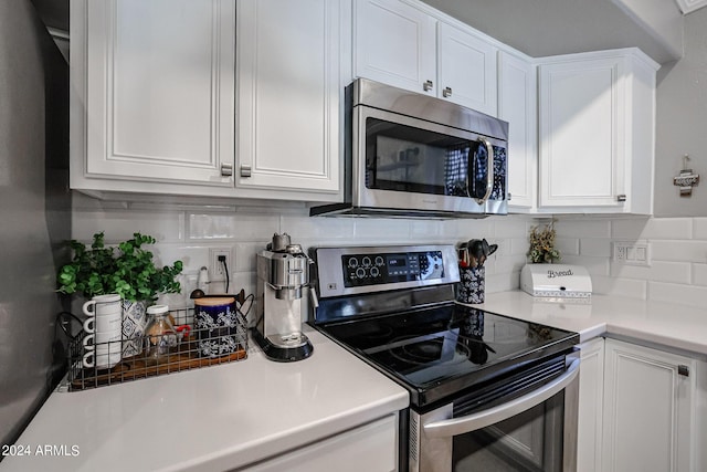 kitchen featuring white cabinetry, tasteful backsplash, and appliances with stainless steel finishes