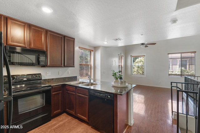 753 N Port Dr, Gilbert, AZ 85233 - kitchen featuring black appliances, a sink, a peninsula, plenty of natural light, and a textured ceiling