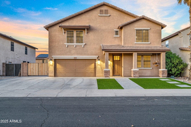 view of front of property with concrete driveway, fence, and stucco siding