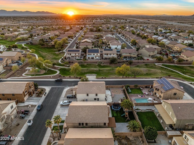 aerial view at dusk featuring a residential view and a mountain view