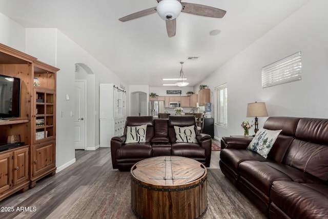 living room with arched walkways, visible vents, dark wood-type flooring, ceiling fan, and baseboards