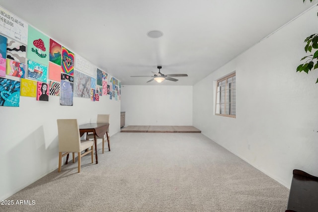 interior space with carpet floors and a ceiling fan