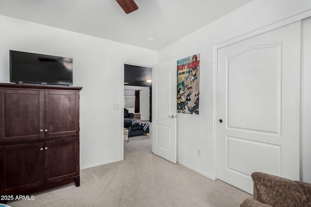 bedroom featuring light carpet, ceiling fan, and baseboards