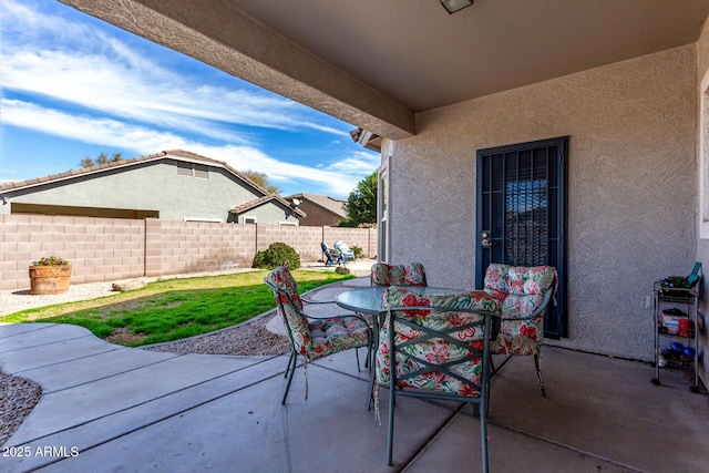 view of patio / terrace with outdoor dining space and fence