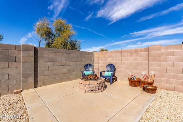 view of patio / terrace with a fenced backyard and a fire pit