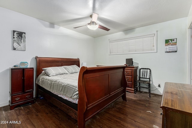 bedroom with ceiling fan and dark wood-type flooring