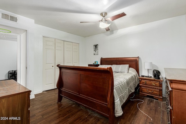 bedroom with a closet, dark hardwood / wood-style floors, and ceiling fan