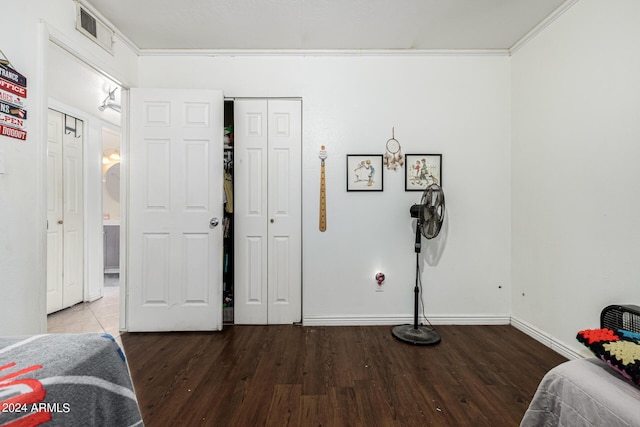 bedroom featuring crown molding and hardwood / wood-style flooring