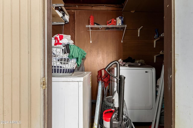 laundry room featuring washer / dryer and wooden walls