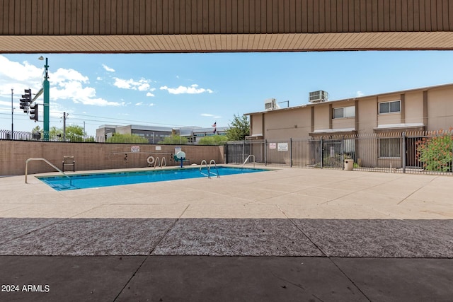 view of pool with central air condition unit