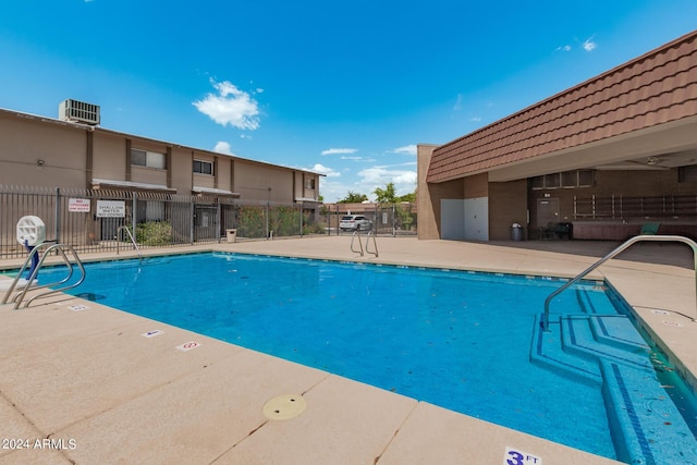 view of swimming pool with central AC unit and a patio area