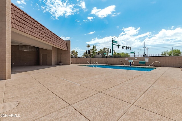 view of swimming pool with a patio area