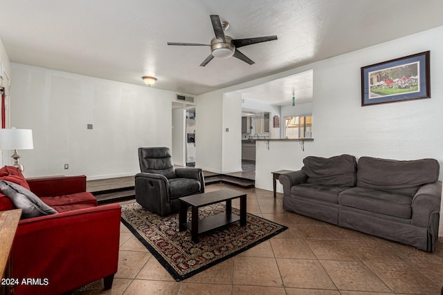 living room featuring tile patterned floors and ceiling fan