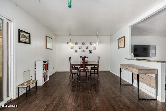 dining space featuring a textured ceiling and dark hardwood / wood-style floors