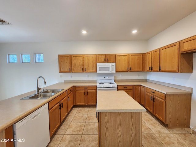 kitchen with kitchen peninsula, sink, light tile patterned floors, and white appliances