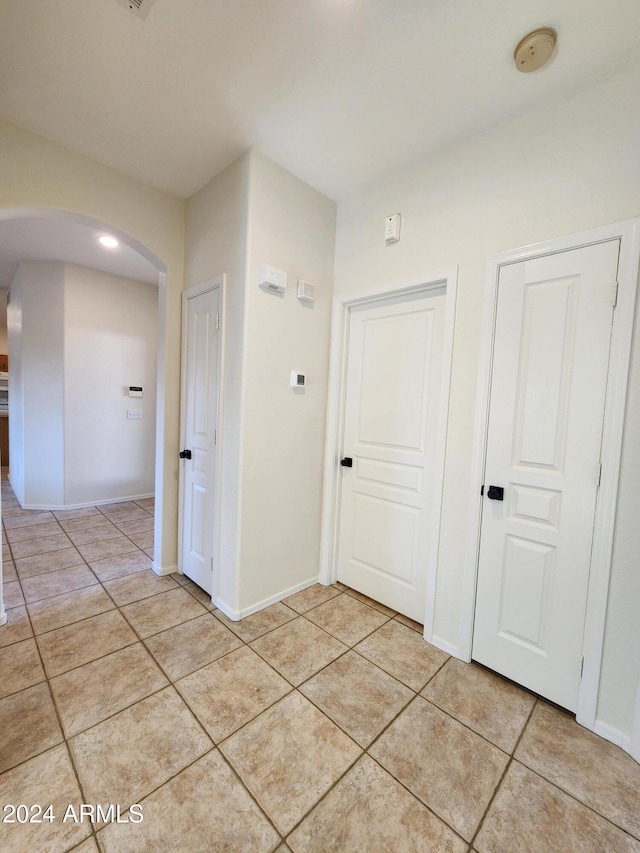 corridor featuring light tile patterned flooring