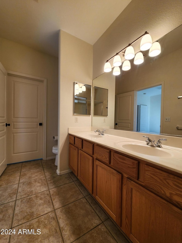 bathroom with tile patterned floors, vanity, and toilet