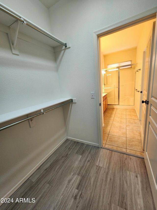 spacious closet featuring hardwood / wood-style flooring