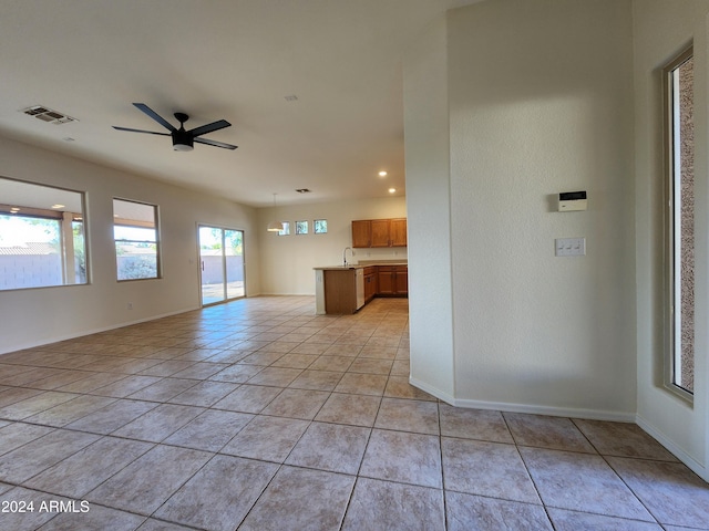 tiled spare room with ceiling fan and sink