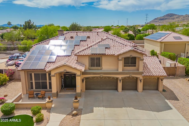 24916 N 80th Ln, Peoria, AZ 85383 - mediterranean / spanish-style home with stucco siding, solar panels, concrete driveway, fence, and a tile roof