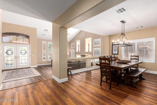 24916 N 80th Ln, Peoria, AZ 85383 - dining space with lofted ceiling, wood finished floors, a chandelier, french doors, and baseboards