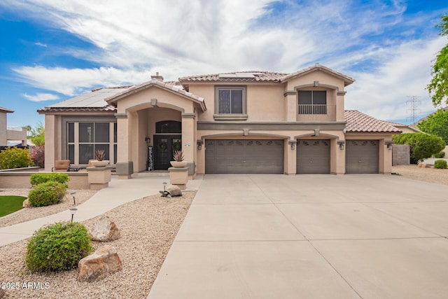 24916 N 80th Ln, Peoria, AZ 85383 - mediterranean / spanish-style house featuring solar panels, stucco siding, a tile roof, an attached garage, and concrete driveway