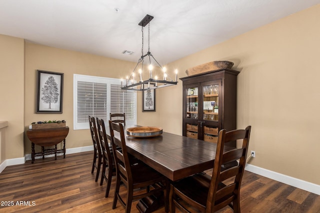 24916 N 80th Ln, Peoria, AZ 85383 - dining area with dark wood finished floors, a chandelier, and baseboards