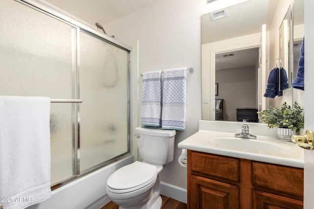 24916 N 80th Ln, Peoria, AZ 85383 - full bath featuring vanity, combined bath / shower with glass door, wood finished floors, toilet, and baseboards