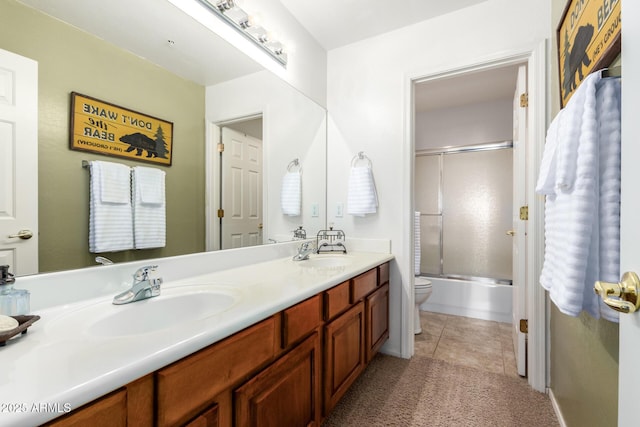 24916 N 80th Ln, Peoria, AZ 85383 - full bath featuring toilet, double vanity, combined bath / shower with glass door, and tile patterned floors