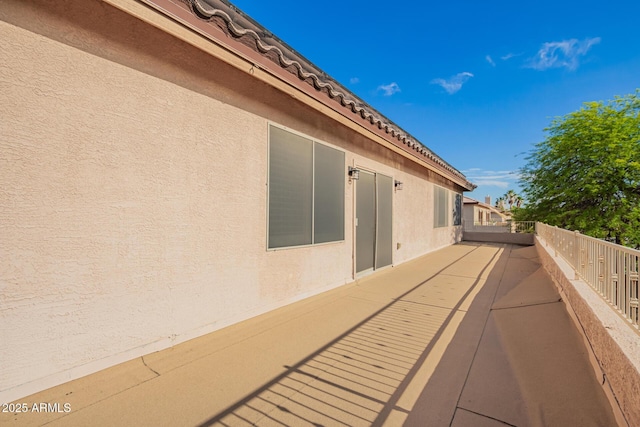 24916 N 80th Ln, Peoria, AZ 85383 - view of side of property with stucco siding and a balcony