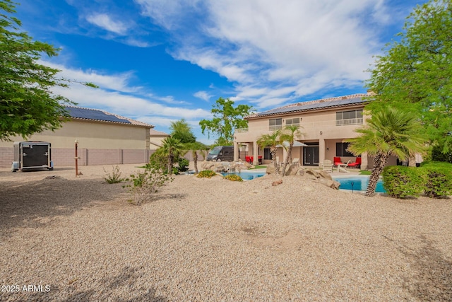 24916 N 80th Ln, Peoria, AZ 85383 - back of house featuring stucco siding, a patio area, an outdoor pool, roof mounted solar panels, and a tile roof
