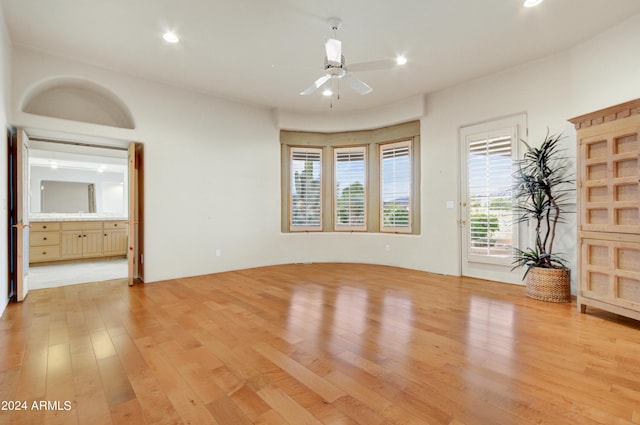 empty room featuring light wood-type flooring and ceiling fan