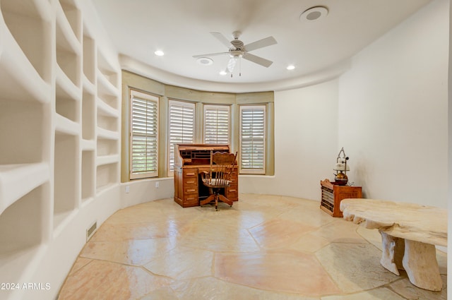 home office with built in features and ceiling fan