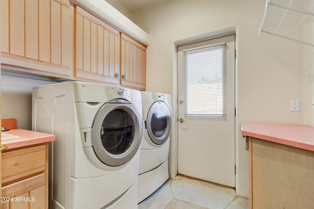 laundry room featuring cabinets, independent washer and dryer, and light tile patterned floors