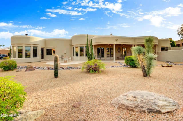 rear view of property with a patio area, ceiling fan, and french doors