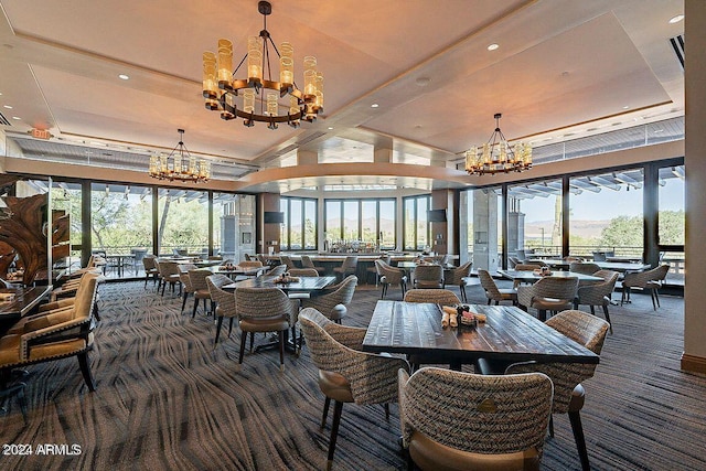 dining space with a notable chandelier, dark carpet, and a healthy amount of sunlight