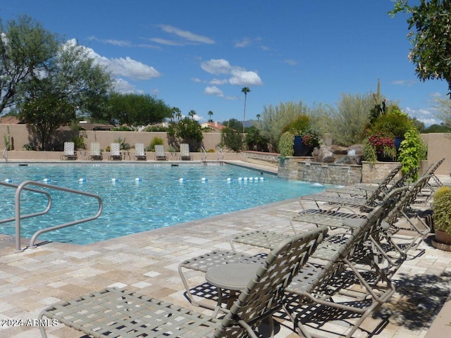 view of pool with pool water feature and a patio area