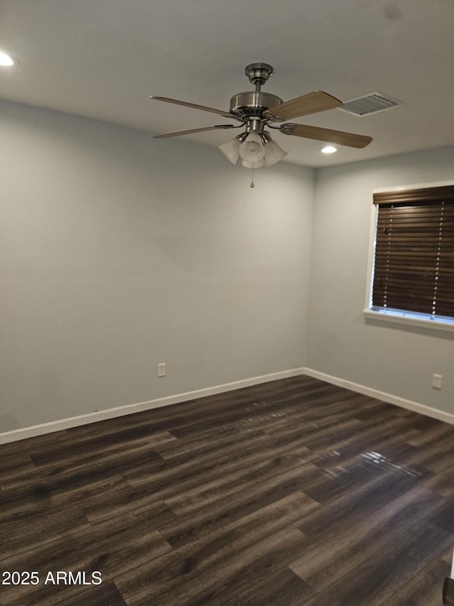 spare room with dark hardwood / wood-style floors and ceiling fan