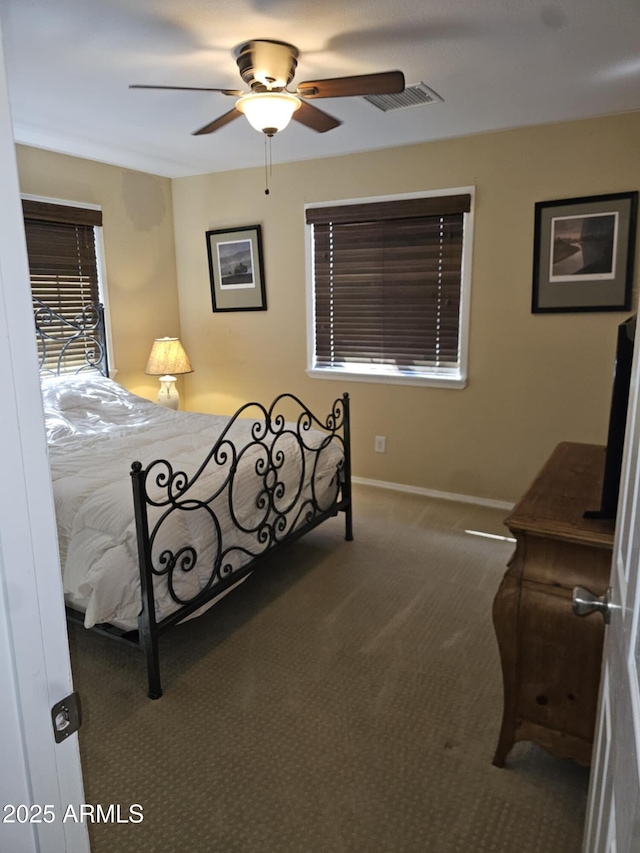 bedroom with dark carpet and ceiling fan