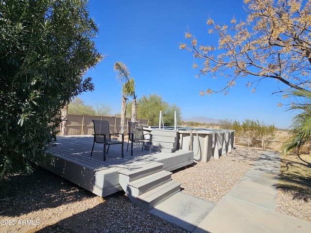 wooden deck with a fenced in pool