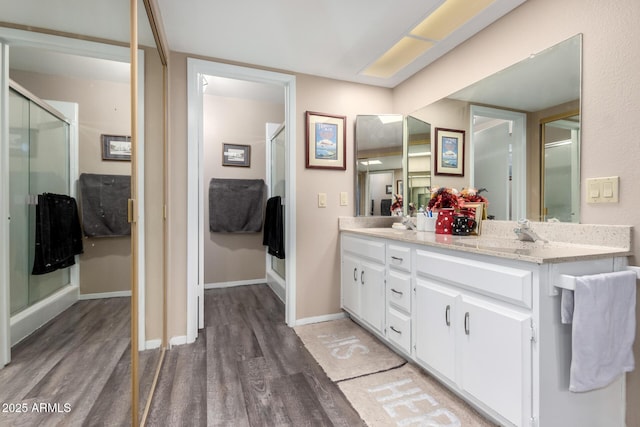 25225 S Glenburn Dr, Sun Lakes, AZ 85248 - bathroom featuring a stall shower, double vanity, and wood finished floors