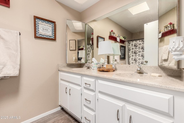 25225 S Glenburn Dr, Sun Lakes, AZ 85248 - bathroom with a sink, double vanity, and baseboards