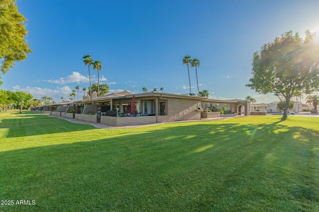 25225 S Glenburn Dr, Sun Lakes, AZ 85248 - back of property featuring a lawn and stucco siding