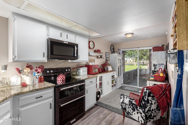 25225 S Glenburn Dr, Sun Lakes, AZ 85248 - kitchen with a textured ceiling, range with two ovens, stainless steel microwave, white cabinetry, and wood finished floors