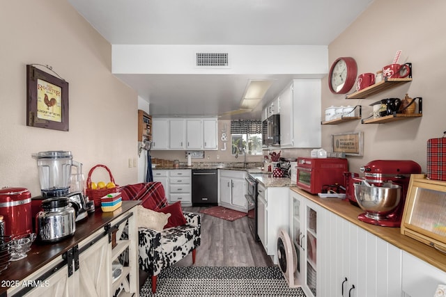 25225 S Glenburn Dr, Sun Lakes, AZ 85248 - kitchen with black dishwasher, visible vents, a sink, stainless steel microwave, and white cabinets